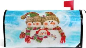 A white mailbox decorated with a winter scene featuring two snowmen, green trees, and falling snow, with a red flag raised.